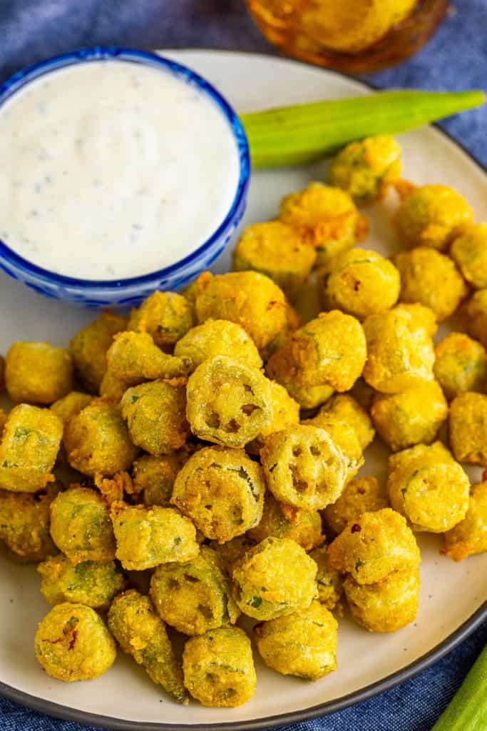 Top down view of a plate of fried okra and ranch dressing.