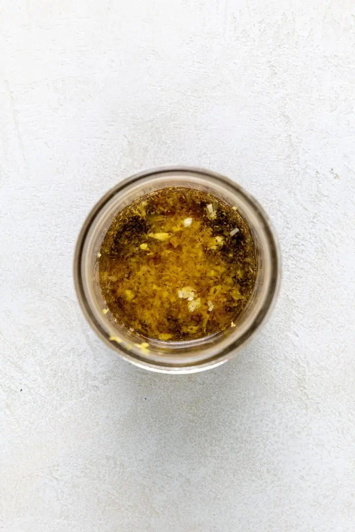 Ingredients for Greek dressing in a jar.