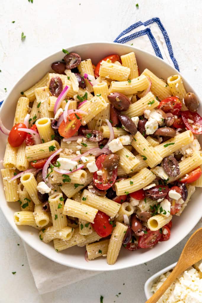 Close up view of rigatoni pasta salad in a dish.