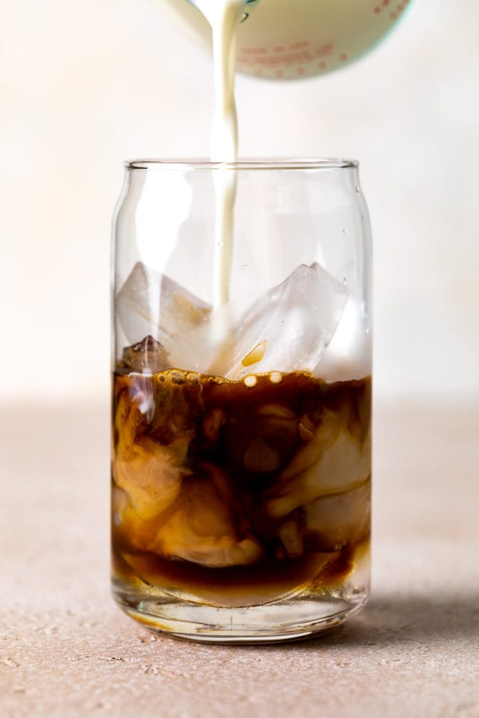 Milk being poured into espresso.