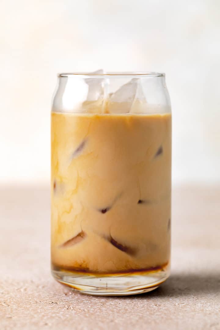 Espresso, millk, and white chocolate syrup in a glass.