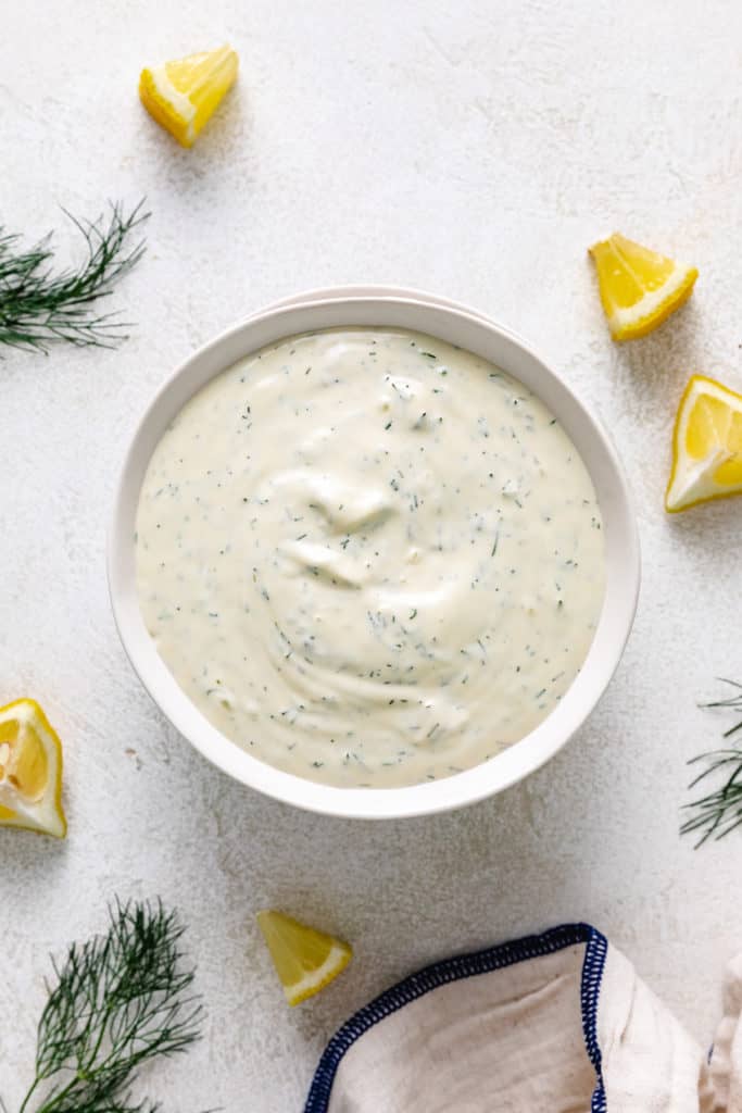 Top down view of a mayo and lemon sauce in a bowl.