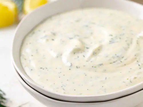 Close up view of bowls of dill sauce.