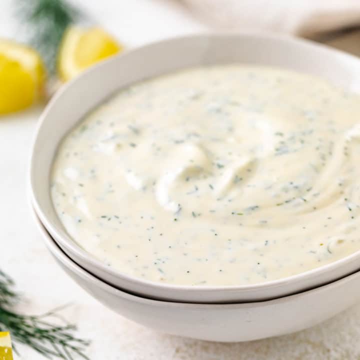 Close up view of bowls of dill sauce.