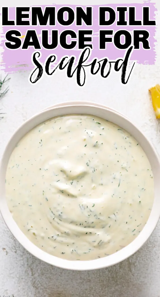 Top down view of a bowl of dill sauce with lemon.