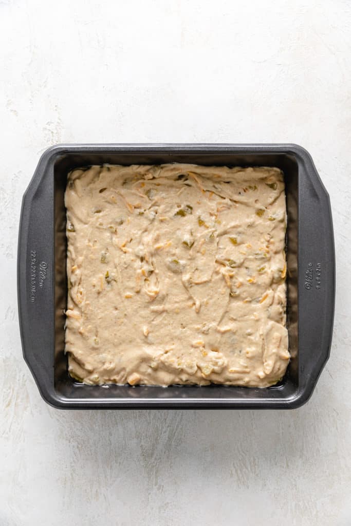 Unbaked cornbread batter in a pan.