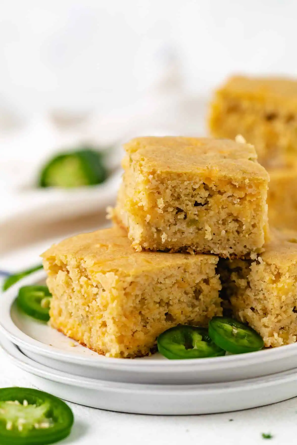 Close up view of masa harina cornbread stacked on plates.