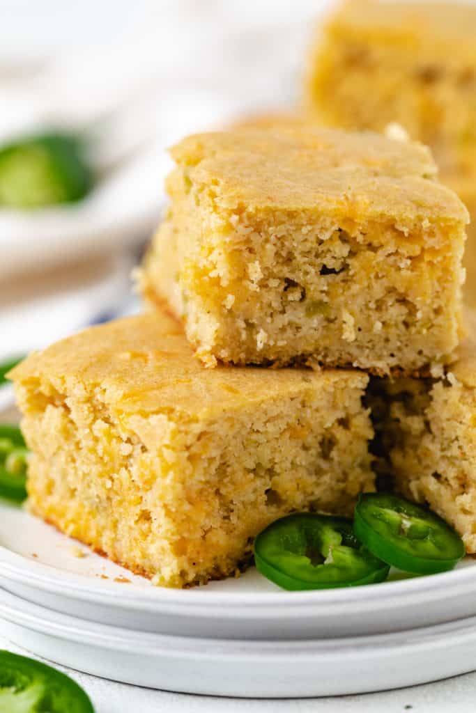 Several pieces of cornbread stacked on two plates.