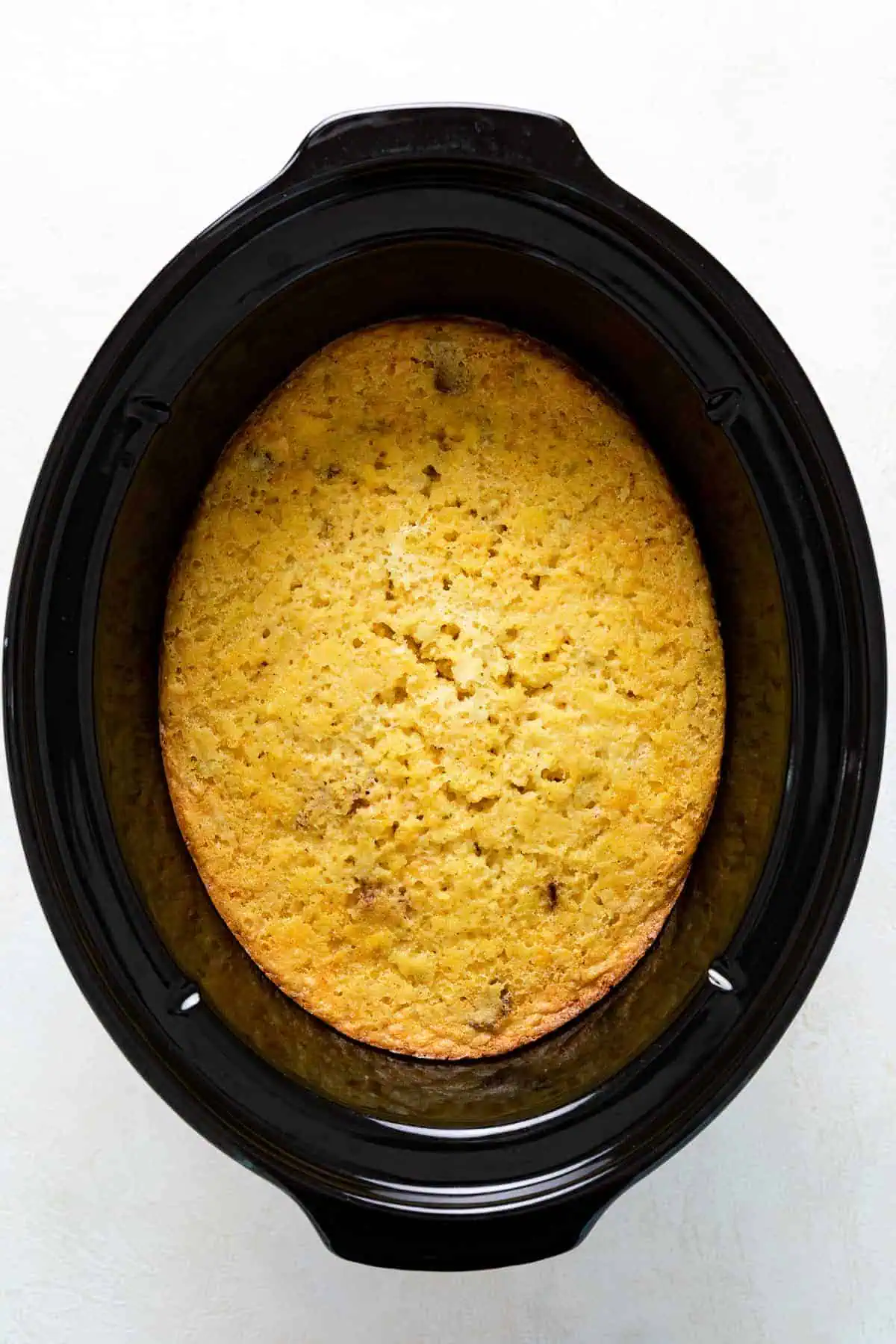 Top down view of corn casserole in a slow cooker.