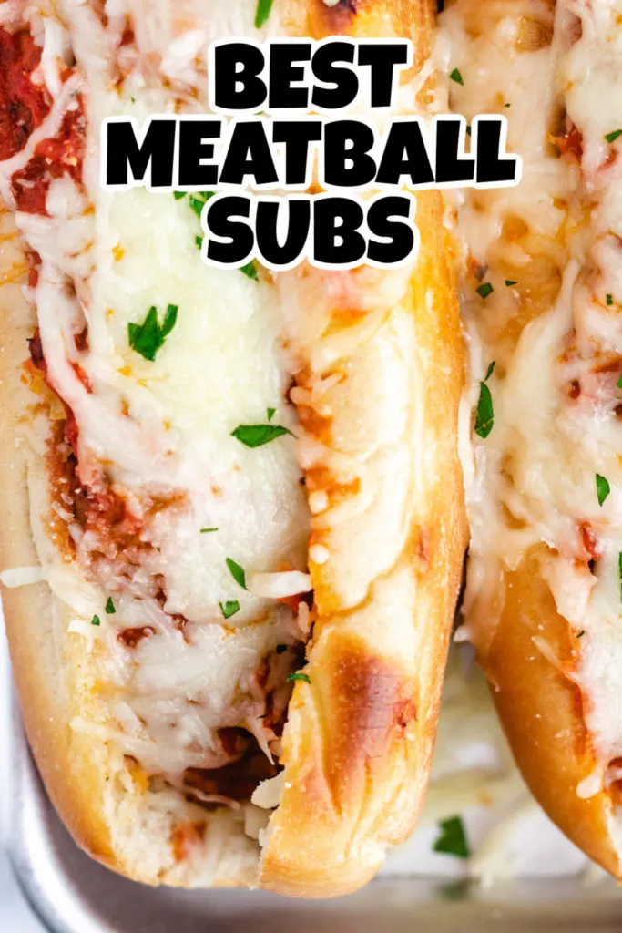 Close up view of a cheesy sub sandwich on a pan.