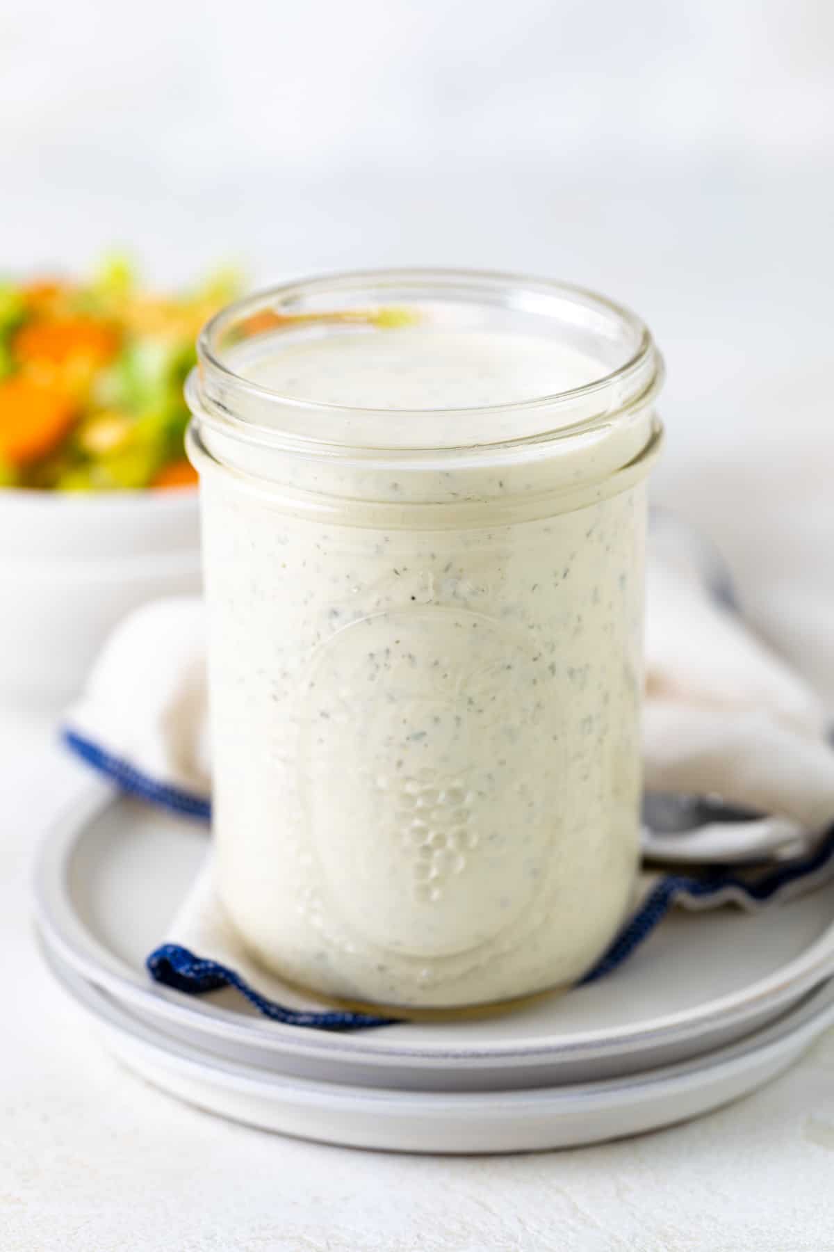 Close up view of a jar of dressing.