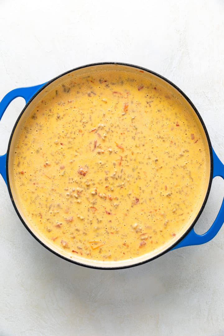 Beef and sausage dip in a large blue pan.