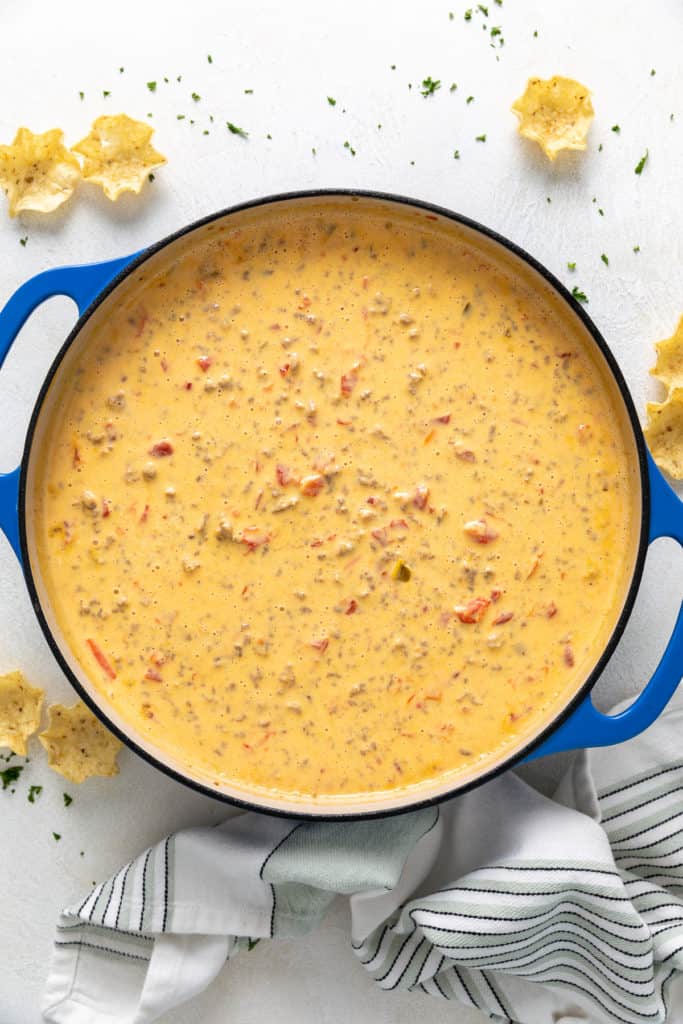 Close up view of cheese dip in a pan next to a linen.