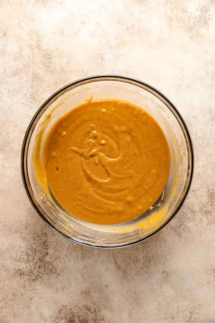 Pumpkin bread batter in a glass bowl.