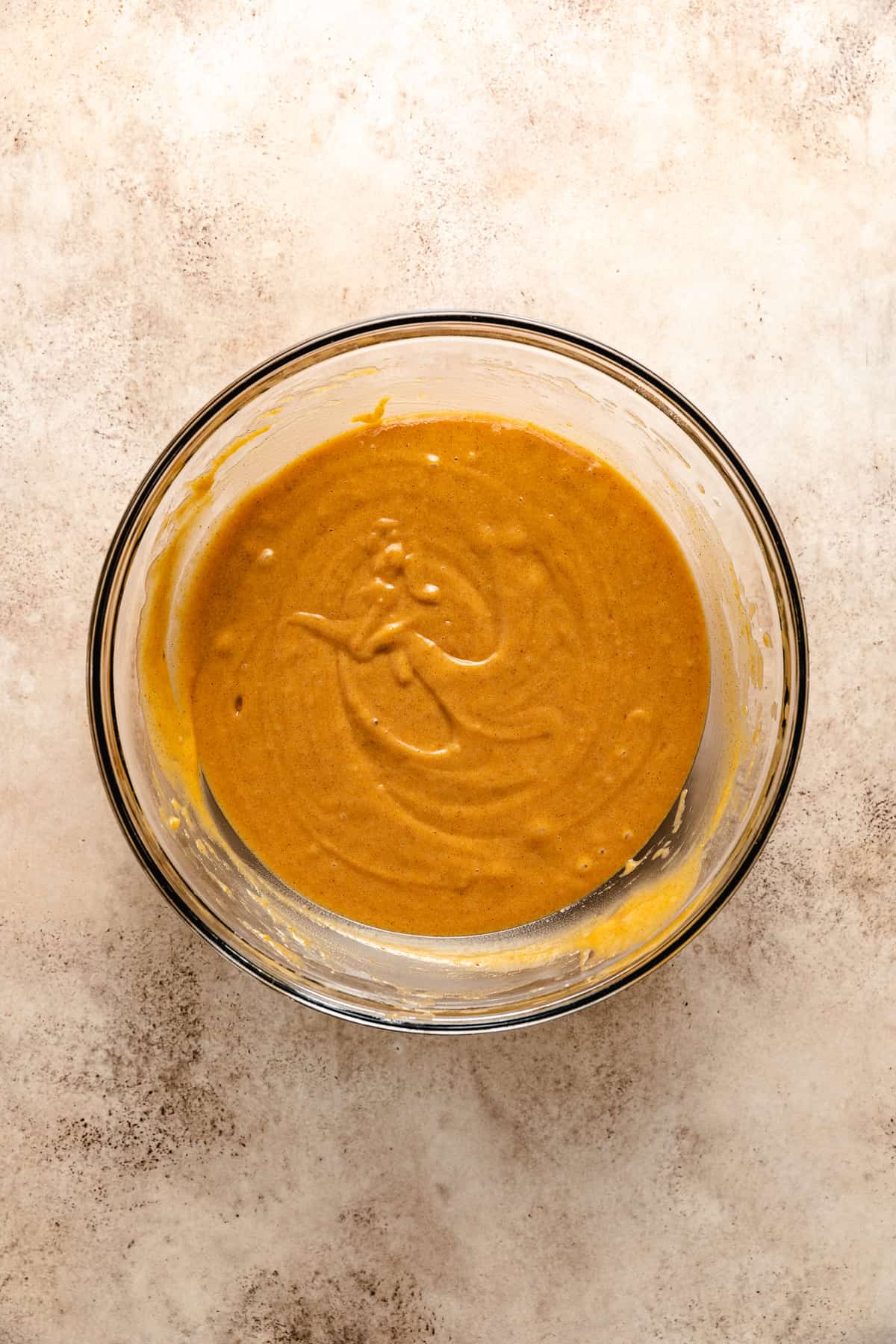 Pumpkin bread batter in a glass bowl.