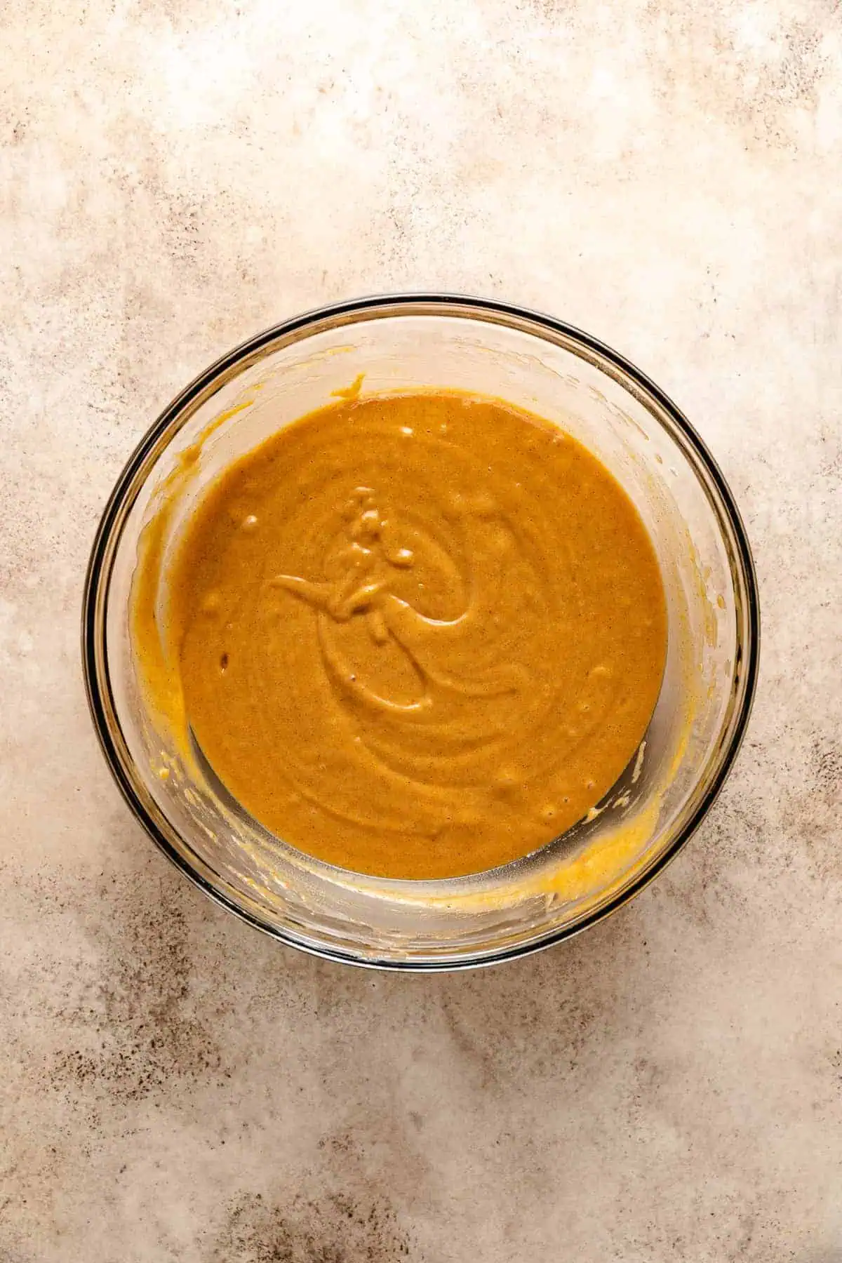 Pumpkin bread batter in a glass bowl.