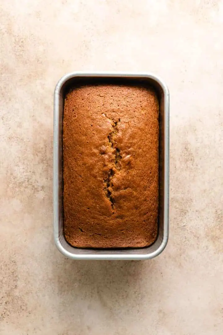 Loaf of pumpkin bread in a pan.