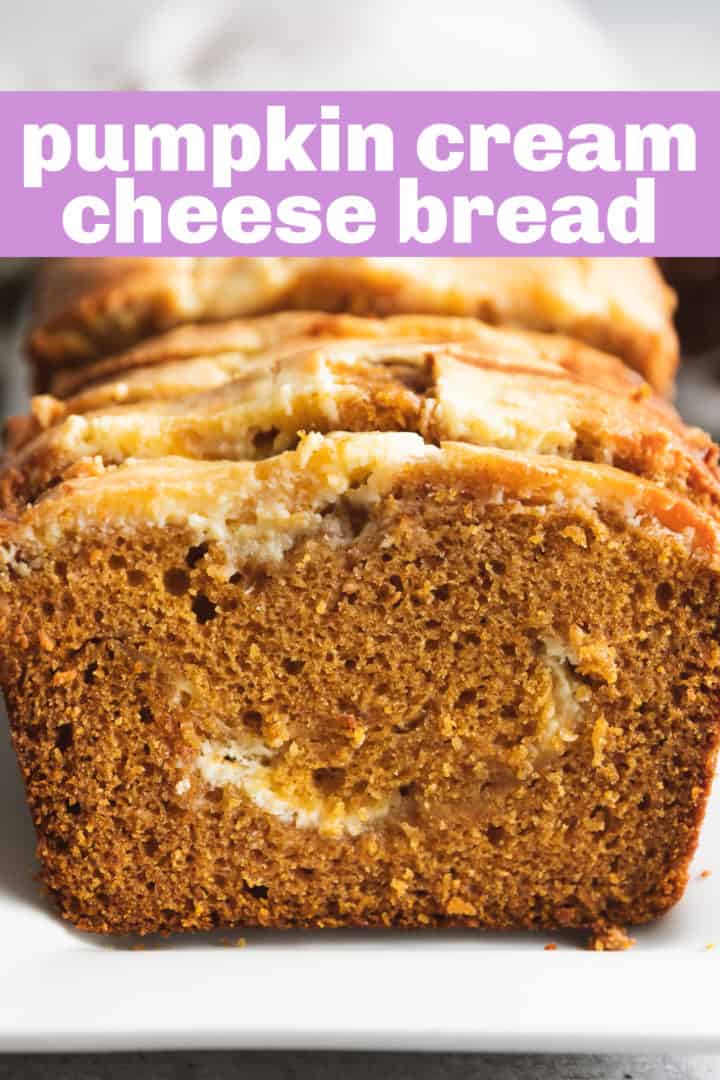 Side view of a loaf of sliced pumpkin bread with cream cheese.