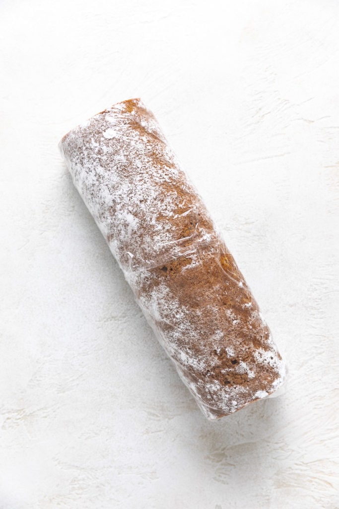 Pumpkin roll wrapped in plastic wrap.