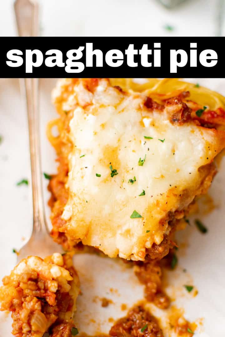 Close up view of a bite of spaghetti pie on a fork.