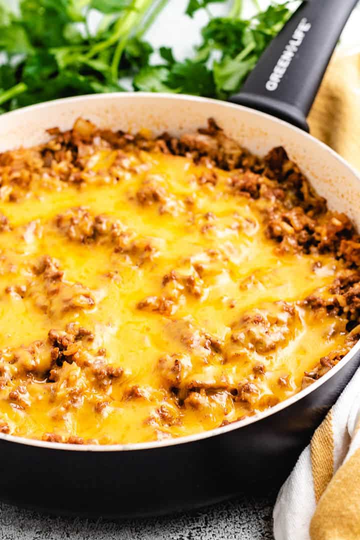 Melted cheese on ground beef and rice.