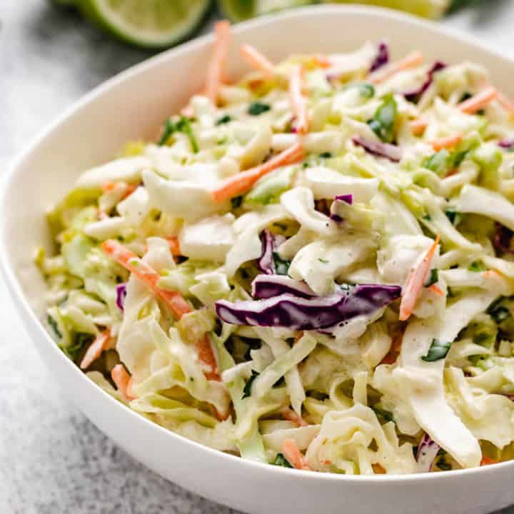 Close up view of a white bowl holding slaw.