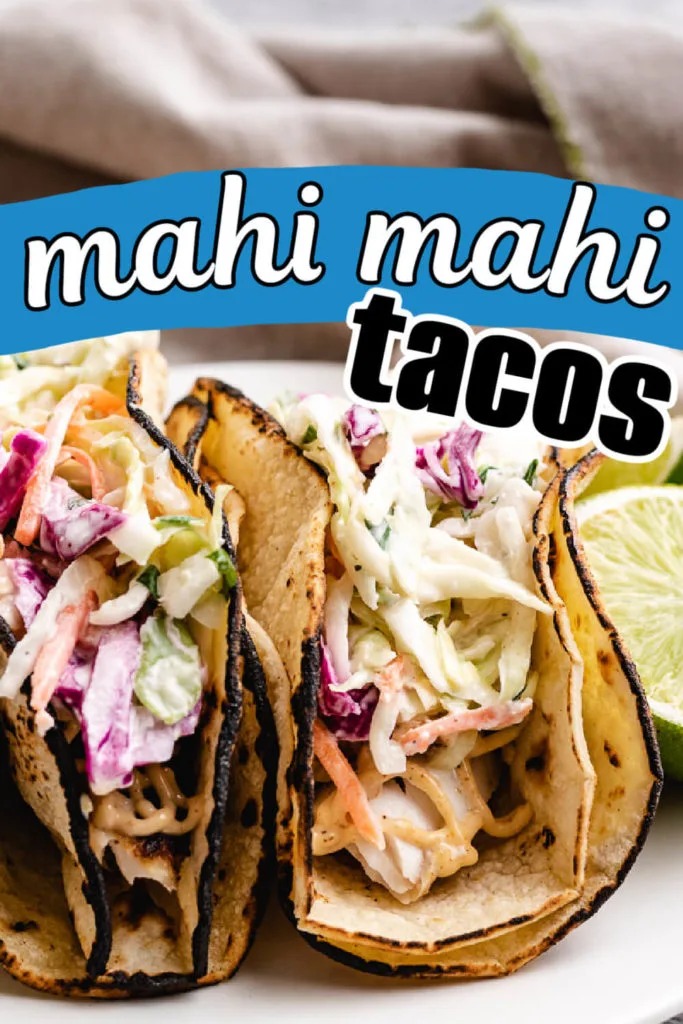 Two mahi mahi tacos with slaw.