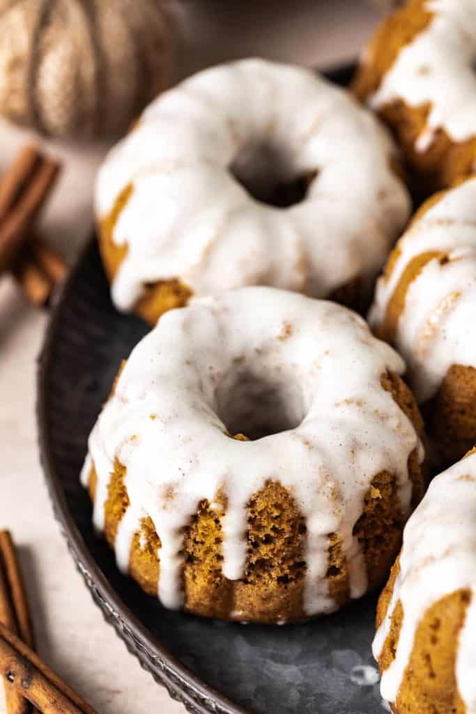 Maple glaze drizzled over small bundt cakes.