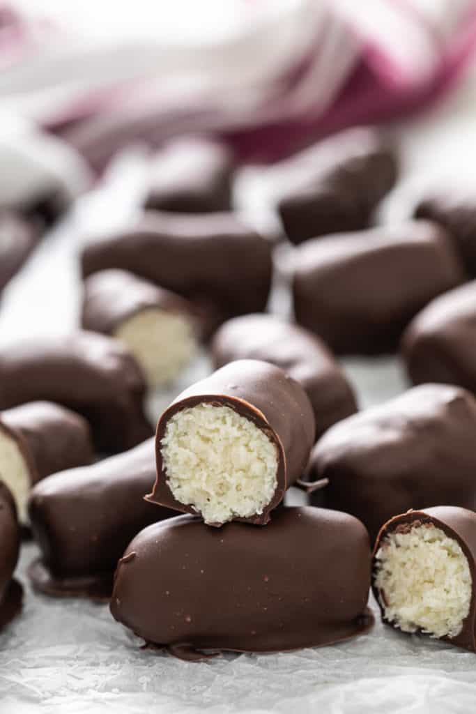 Batch of homemade mounds bars on parchment paper.