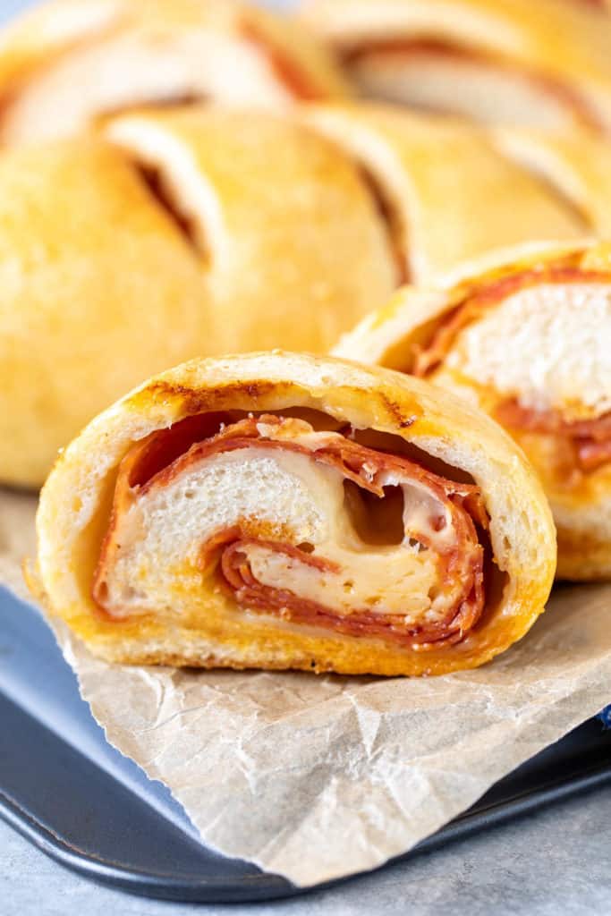 Side view of a cheesy pepperoni roll.