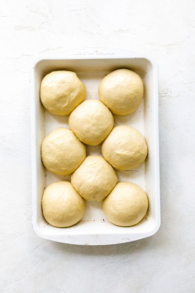 Risen and unbaked dough in a pan.