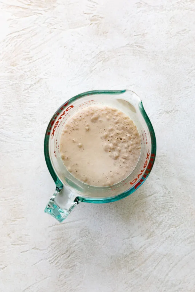 Activated yeast in a measuring cup.