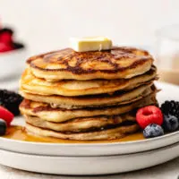 Stack of pancakes on two plates.