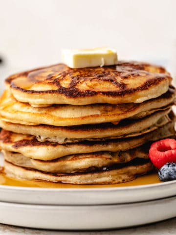 Stack of pancakes on two plates.