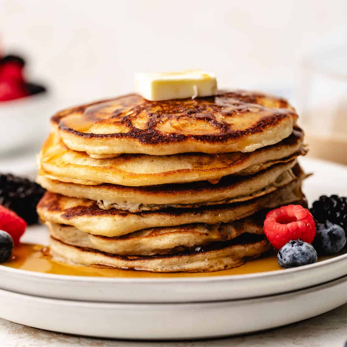 Stack of pancakes on two plates.