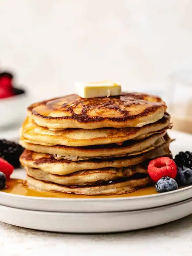 Flapjacks and fruit on a plate.