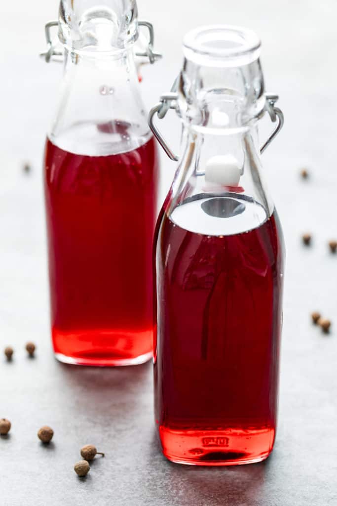 Two jars of homemade grenadine.