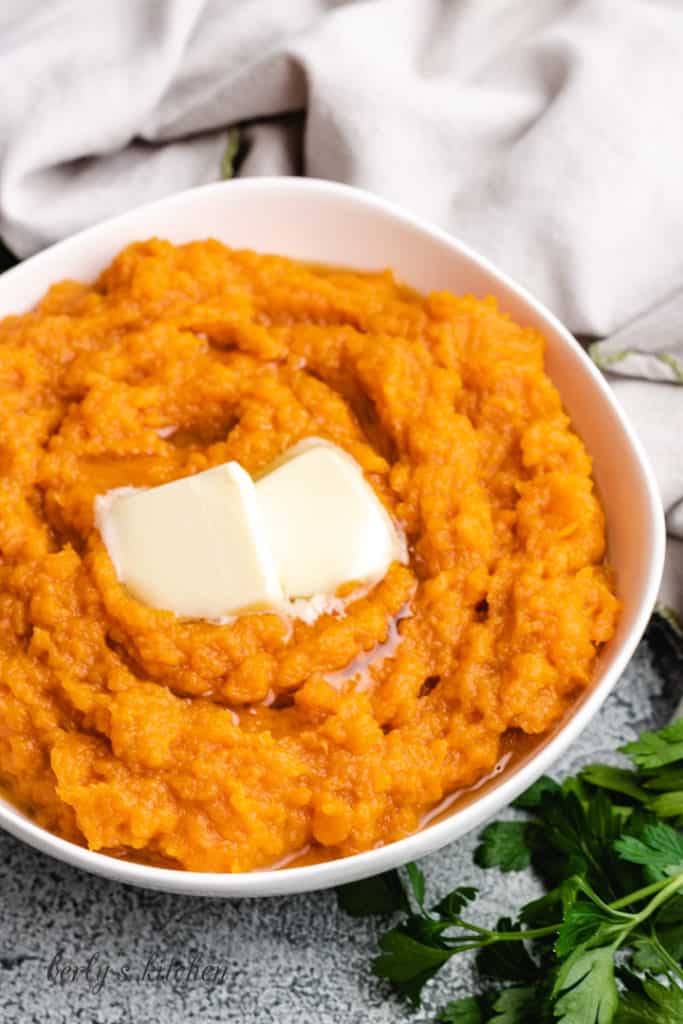 Side view of instant pot mashed sweet potatoes in a bowl.