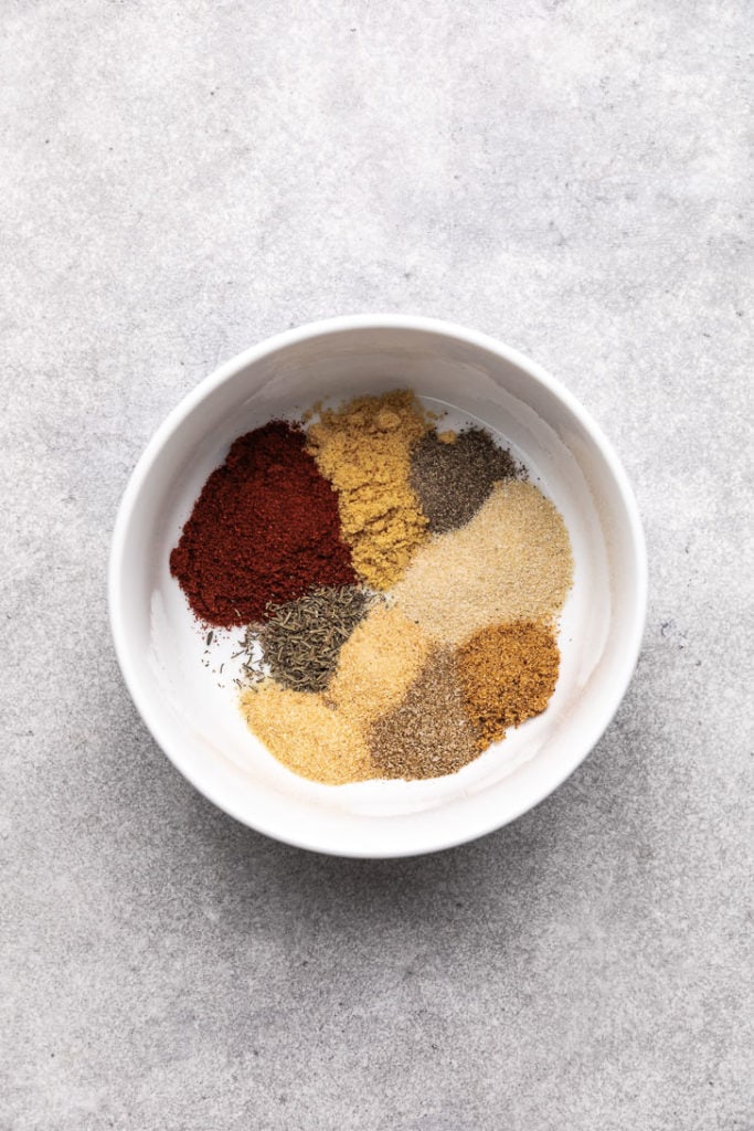 Spices poured into a white bowl.