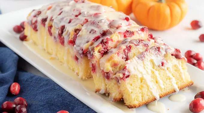 Side view of a loaf sliced orange cranberry bread.