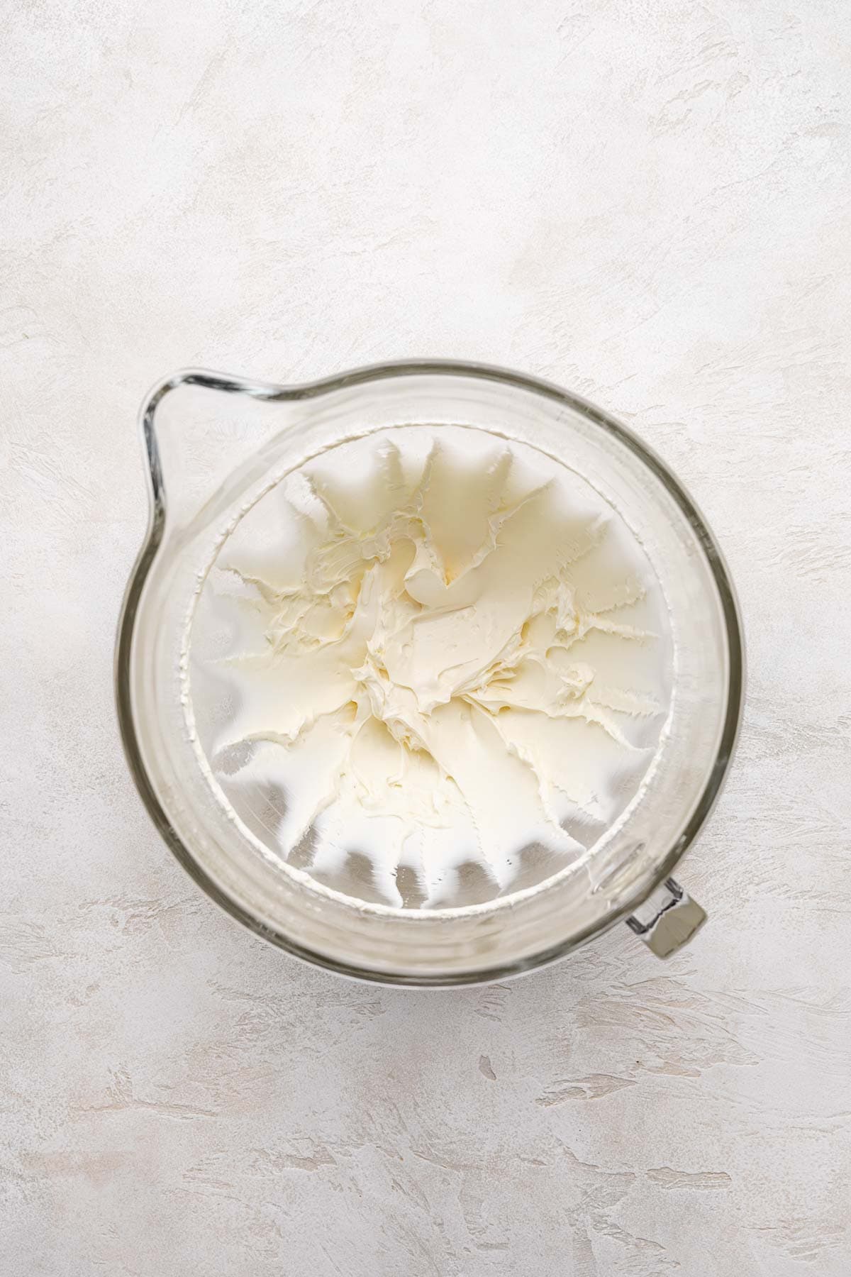 Beaten cream cheese in a mixing bowl.
