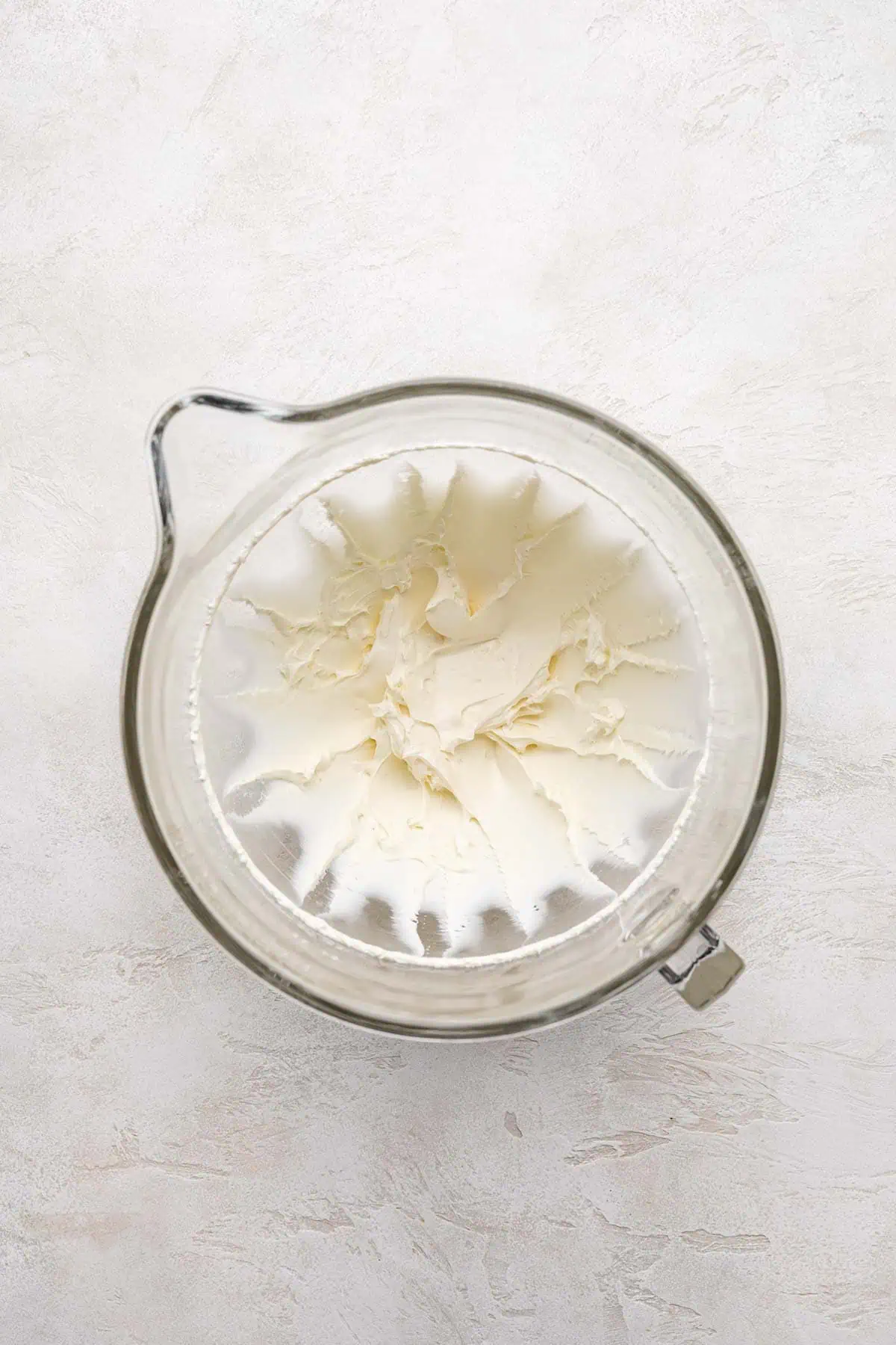 Beaten cream cheese in a mixing bowl.