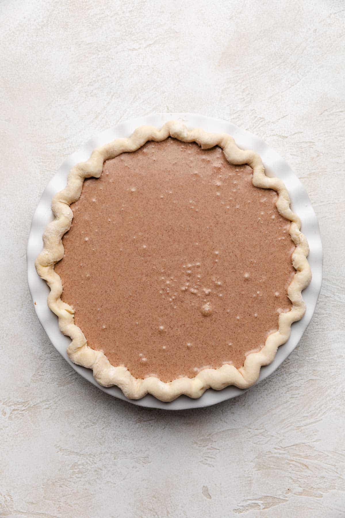 Top down view of unbaked filling in a pie shell.