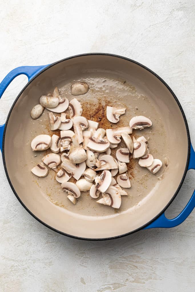 Mushrooms and oil in a pan.