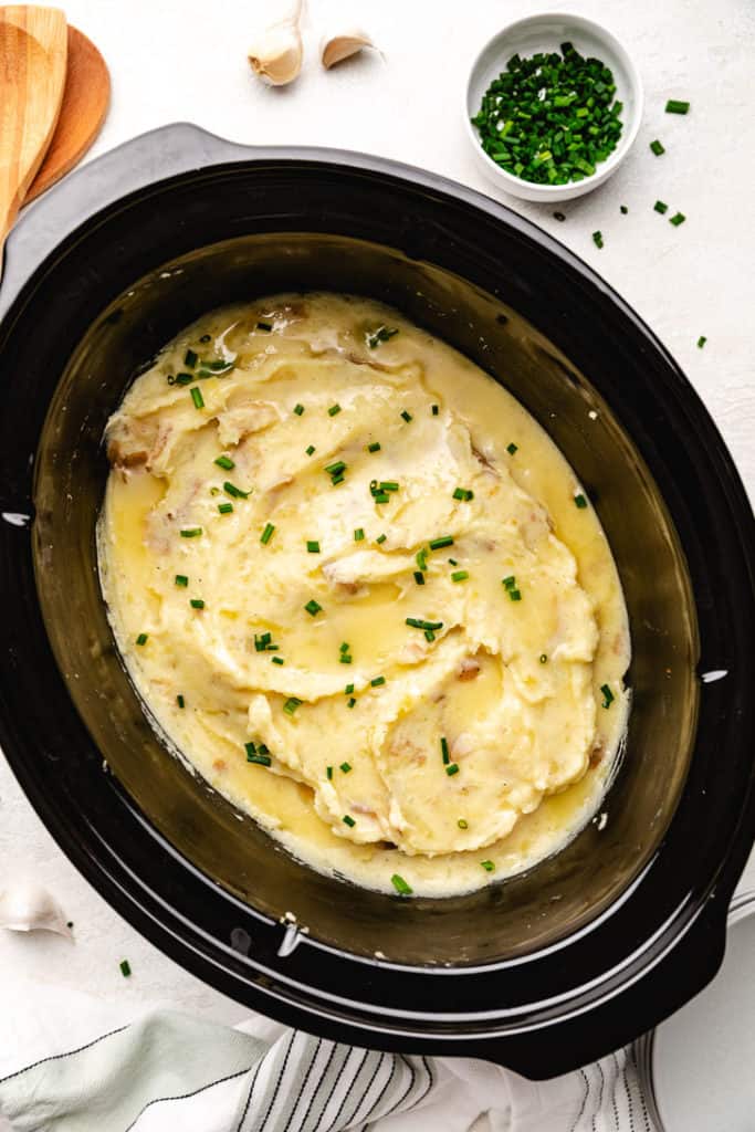 Chives sprinkled over buttery mashed potatoes.