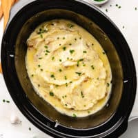 Top down view of creamy potatoes in a slow cooker.