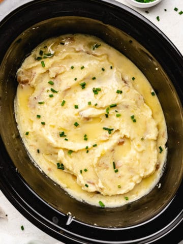 Top down view of creamy potatoes in a slow cooker.
