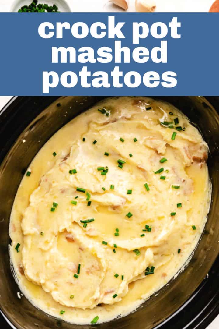 Crock pot filled with creamy mashed potatoes.