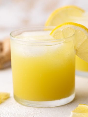 Side view of a glass of spicy ginger ale.