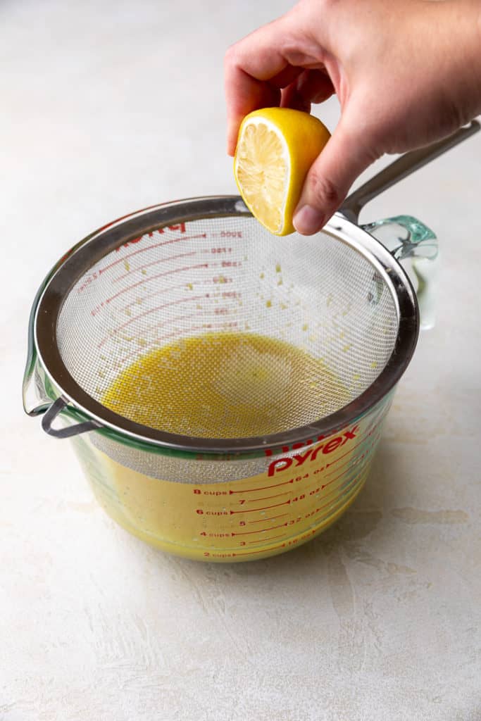 Lemon juice being added to simple syrup.